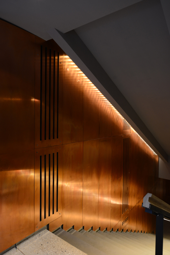 Descent to the cloakroom, basement floor. The walls are covered with copper panels. "Electrotheater Stanislavsky". Photo  Ilia Ivanov, 2014