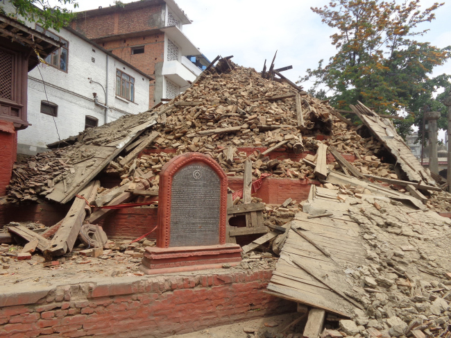 Collapsed Chasin Dega at Hanuman Dhoka behind a stone plaque indicating World Heritage status  Kai Weise
