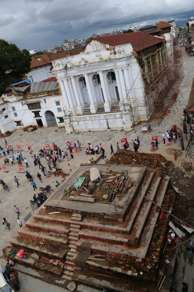 A view of Hanuman Dhoka Durbar Square with the cleared plinth of a collapsed Narayan temple in the foreground with the critically damaged Rana style Gaddhi Baitak.  Kai Weise