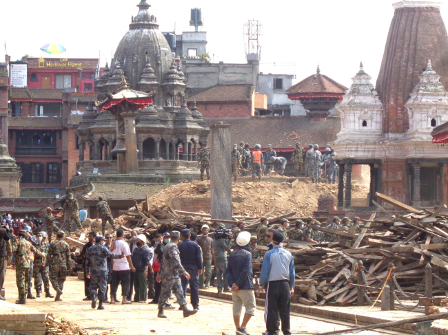 Salvaging work going on after the earthquake with help from army and police, Patan Durbar Square.  Kai Weise