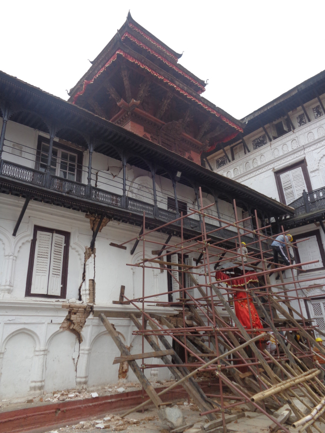 Shoring to protect the facade collapsing onto the main Hanuman Statue with the intact Agamchhen temple that is raise on timber stilts over the palace.  Kai Weise
