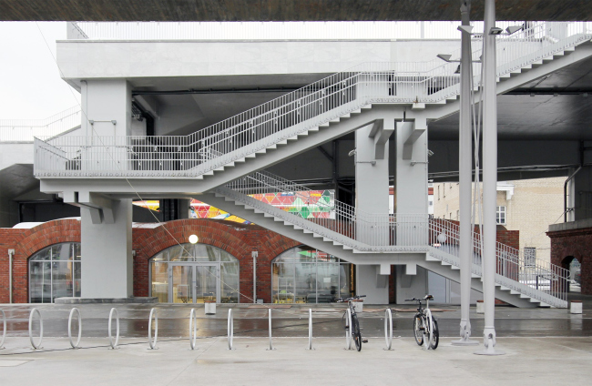 The staircases that lead to the pedestrian bridge have silhouettes that resemble the inner ones, but these are constructed in a simpler way with bridgeboards. In the background: a copy of the “vaulted” building that appeared a while ago. It is n