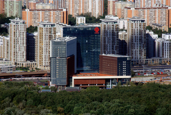 View from the Ostankino TV tower. The “Huamin” center on the Vilgelma Pika Street / TPO Reserve (in the center) against the background of the housing construction on the Serebryakova Drive