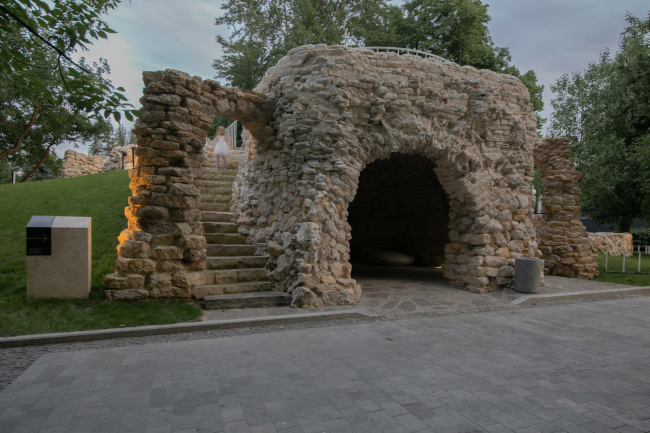 To the left, next to the information plaque  the restored left arch. The grotto of the XIX century in Moscow′s Bauman Garden. Restoration 2018-2022